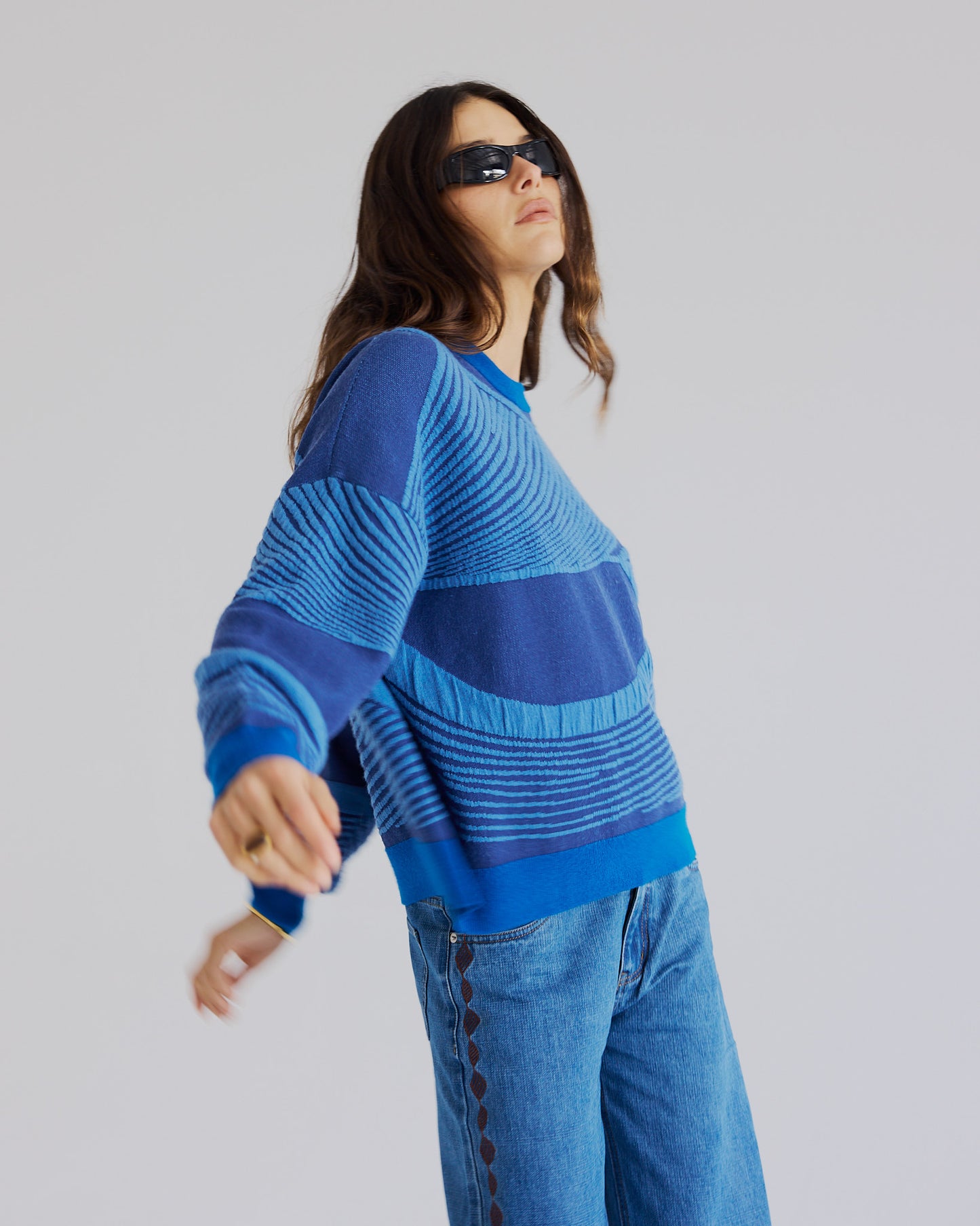 Textured jacquard knit detail on blue merino wool Snowy Sweater.